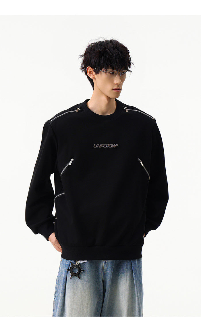 Black crew neck sweatshirt with silver shoulder zippers, angled zip pockets, and a small chest graphic on a model