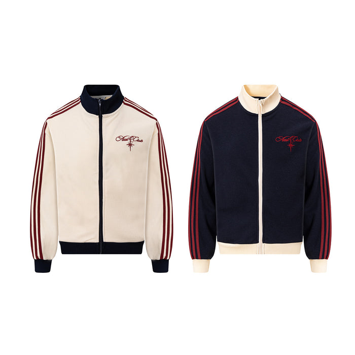 Two waffle-knit track jackets shown front-facing in cream and navy, with embroidered logos and red striped sleeves
