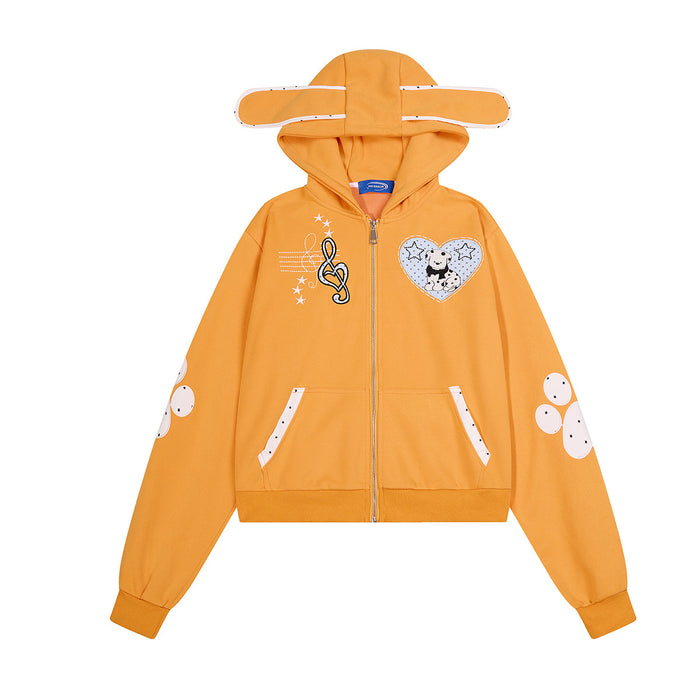 Front view of the orange cropped zip-up hoodie with ear-shaped hood, dog heart patch, musical note graphic and paw prints