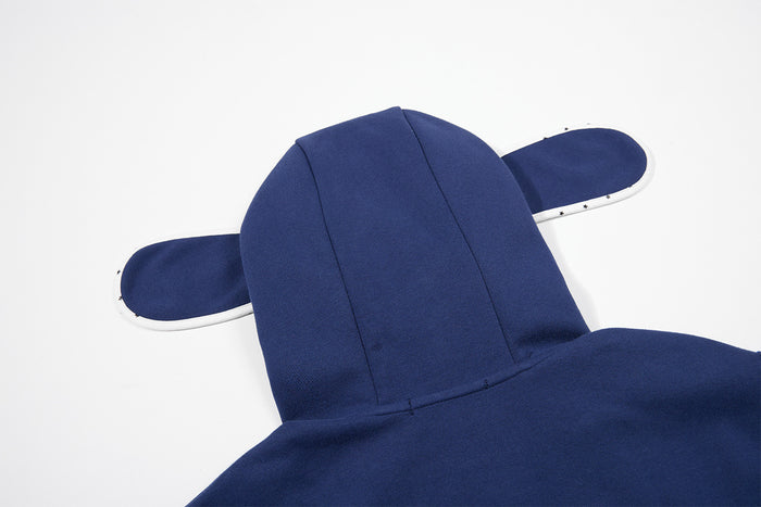 Close-up of the navy hoodie back showing the structured hood and extended ear-shaped side panels