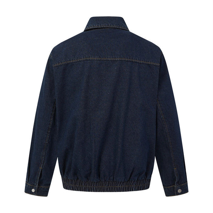 Back view of a dark wash denim jacket with a pointed collar, horizontal yoke seam, and elasticized hem