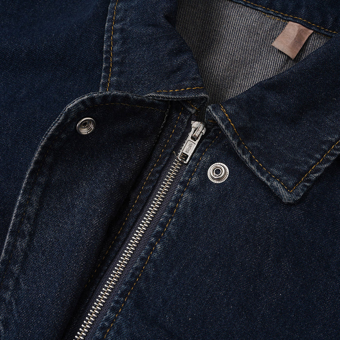 Close-up of the denim jacket collar and front closure showing a metal zipper and snap buttons