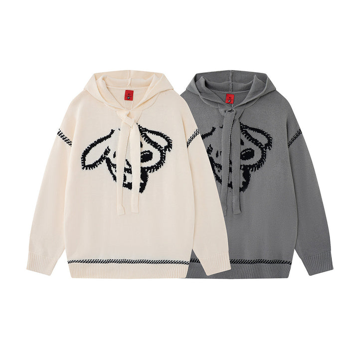 Front view of cream and gray knit hoodies with black animal face graphics and patterned trim