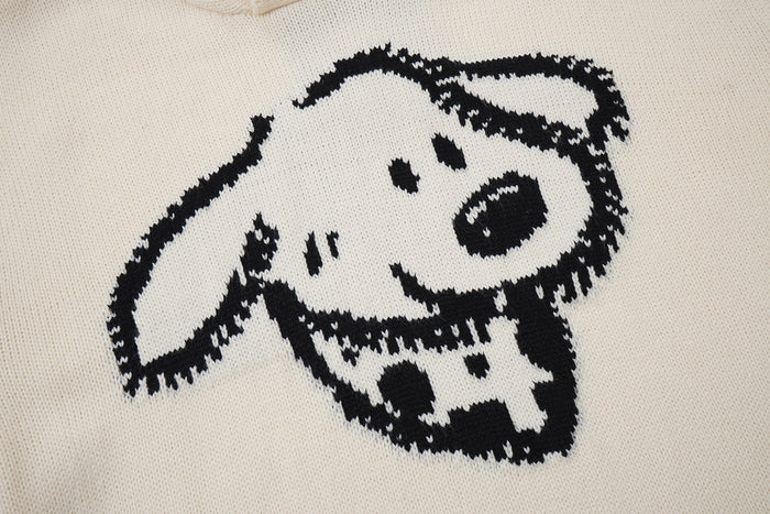 Close-up of the black animal face graphic knitted into the cream sweater front