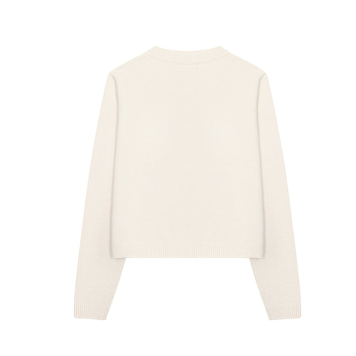 Back view of the cream knit cardigan showing its plain design, round neckline, long sleeves, and ribbed hem