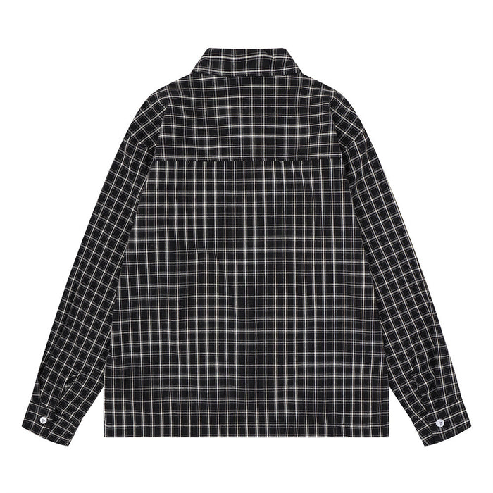 Back view of a black plaid long sleeve shirt showing the checked pattern, yoke seam, and buttoned cuffs