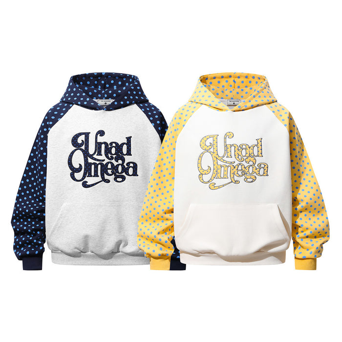 Two colorblock raglan hoodies, navy and yellow, with blue polka dots and large front lettering