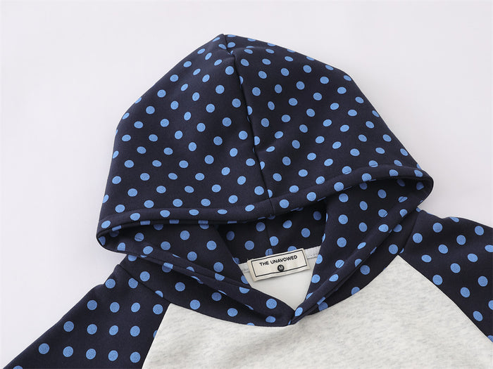 Close-up of the navy blue polka dot hood, neckline, and sewn-in label