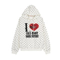 Cream oversized pullover hoodie with black polka dot print and I Care About Your Future red heart graphic on chest