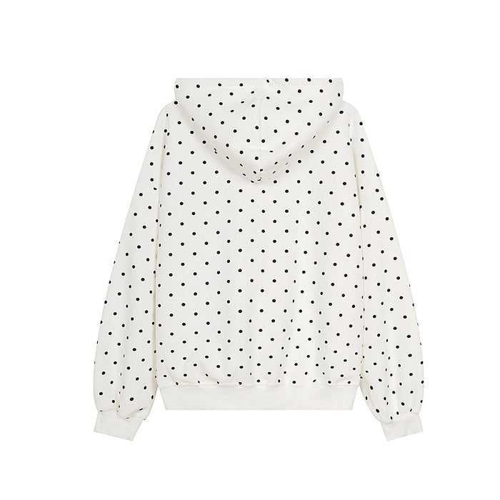 Back view of a cream hoodie covered in black polka dots, with a hood, long sleeves, and ribbed hem