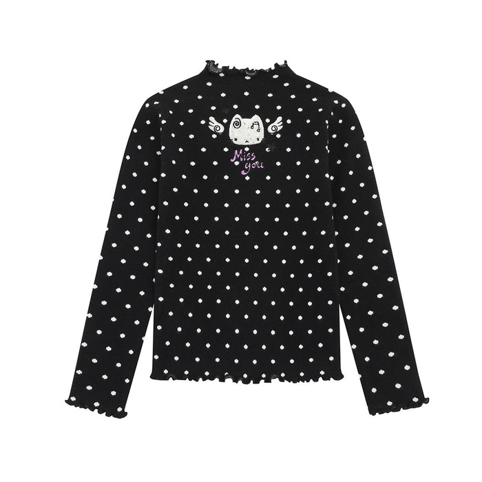 Front view of a black polka dot knit sweater with winged cat graphic and lettuce edges