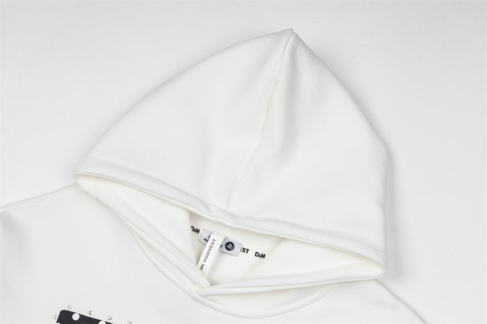 Close-up of the white hoodie’s hood, neckline, stitching, and sewn-in label