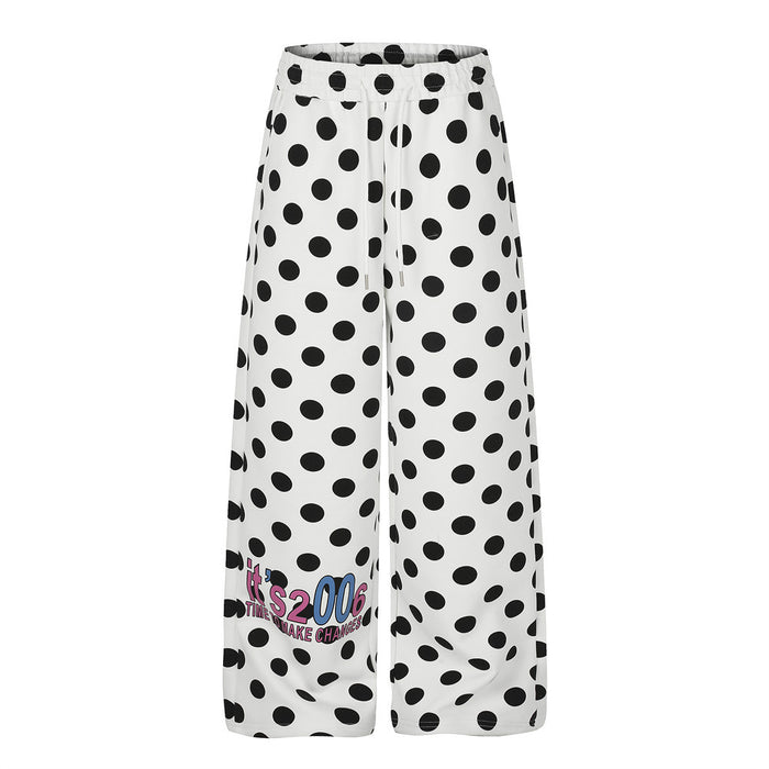 White wide-leg sweatpants with all-over black polka dot print and retro colorful letter graphic at the lower leg