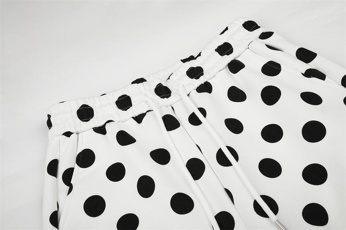 Close-up of the polka dot pants waistband with gathered elastic, front pleats, and drawstring opening