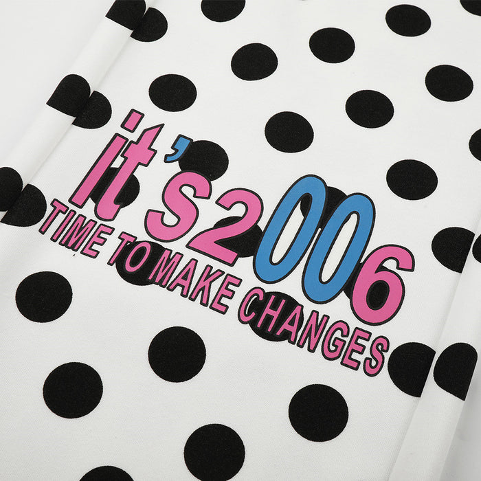 Close-up of colorful printed lettering reading Its 2006 Time to Make Changes on the polka dot pants