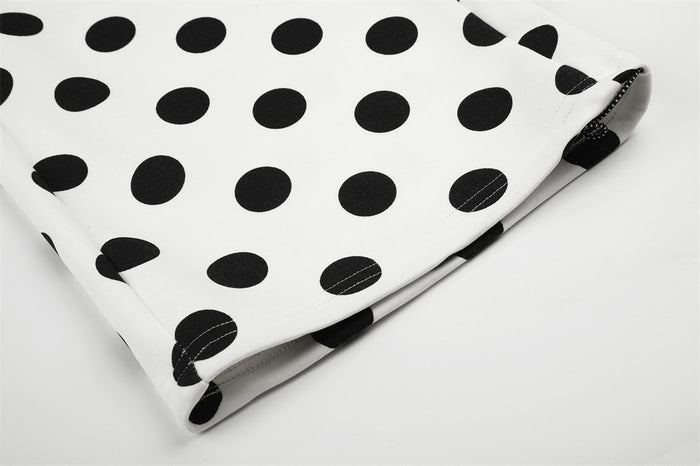 Close-up of the wide pant leg hem showing folded fabric, black polka dots, and stitched edge detail