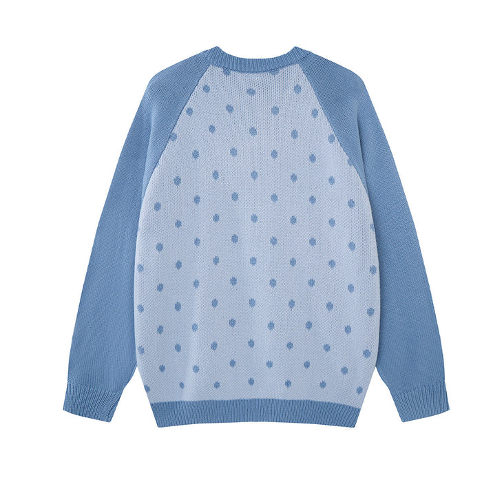 Back view of the light blue knit cardigan featuring a pale blue polka dot pattern and ribbed trim