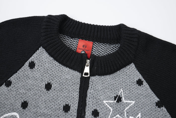 Close-up of the black cardigan’s ribbed collar, front zipper, gray knit panel and red neck label