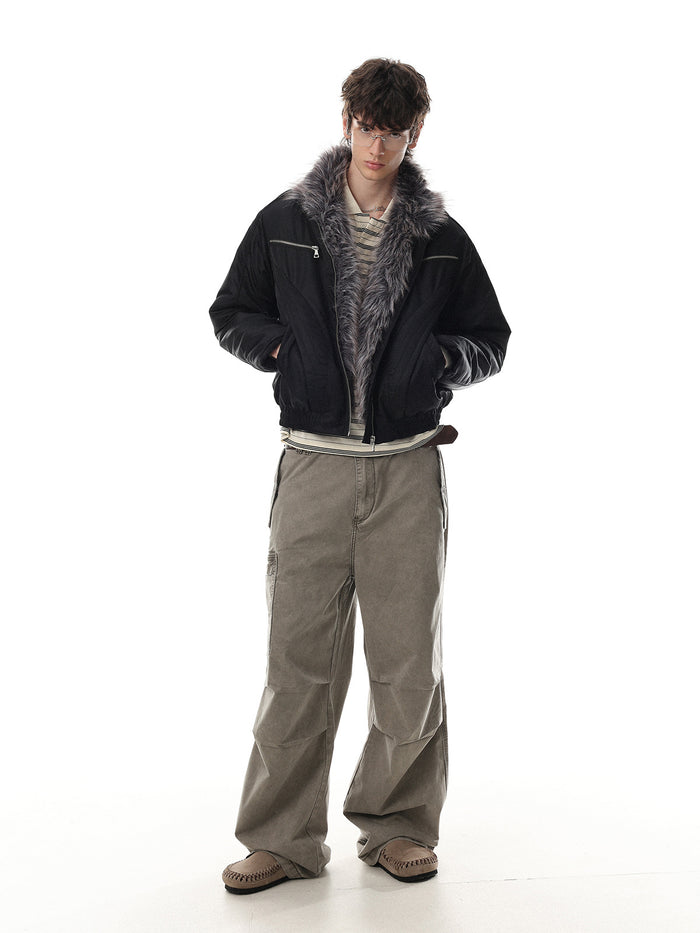 Full-length model view showing a black padded jacket with faux fur collar, layered styling, and relaxed fit
