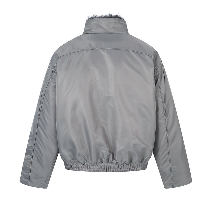 Back view of the gray padded jacket with a plain shell, raised collar, stitched sleeves, and elasticized hem