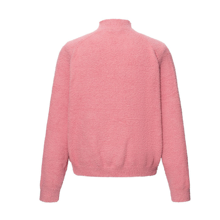 Back view of the pink zip-up knit sweater showing its plain bouclé texture