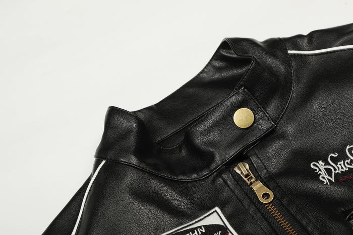 Close-up of the black PU leather jacket collar with snap button, gold zipper and white piping