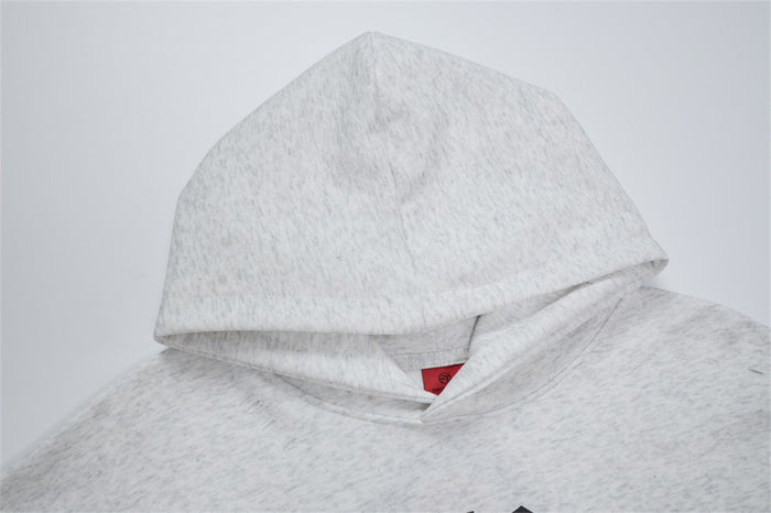 Close-up of the light gray hoodie hood showing its layered edge and soft textured fabric