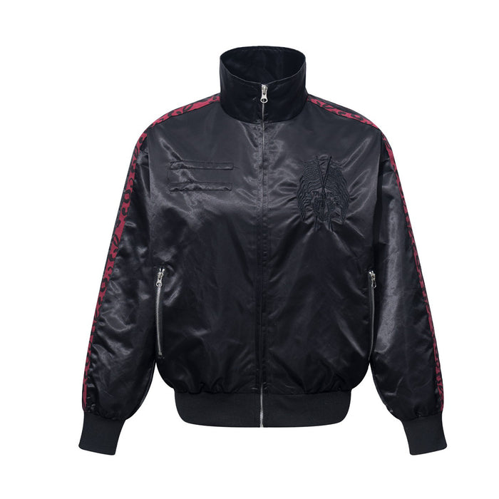 Black satin bomber jacket front with stand collar, embroidered chest emblem, zip pockets, and red leopard stripe tape