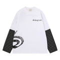 White oversized long sleeve tee front with black chest lettering, black plaid sleeve panels, and a distressed side graphic