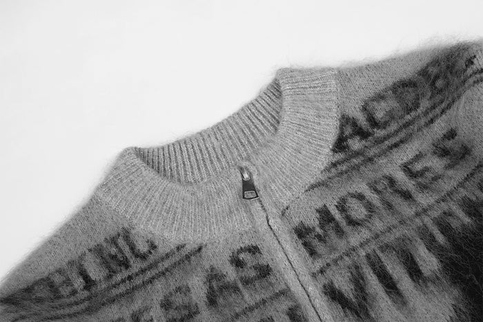 Close-up of the gray cardigan collar and metal zipper against the fuzzy knit jacquard front