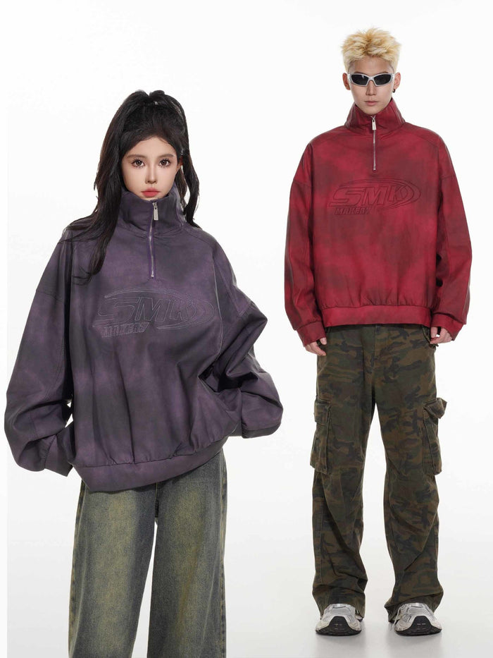 Two models wearing red and charcoal acid-wash half-zip pullovers in a front view