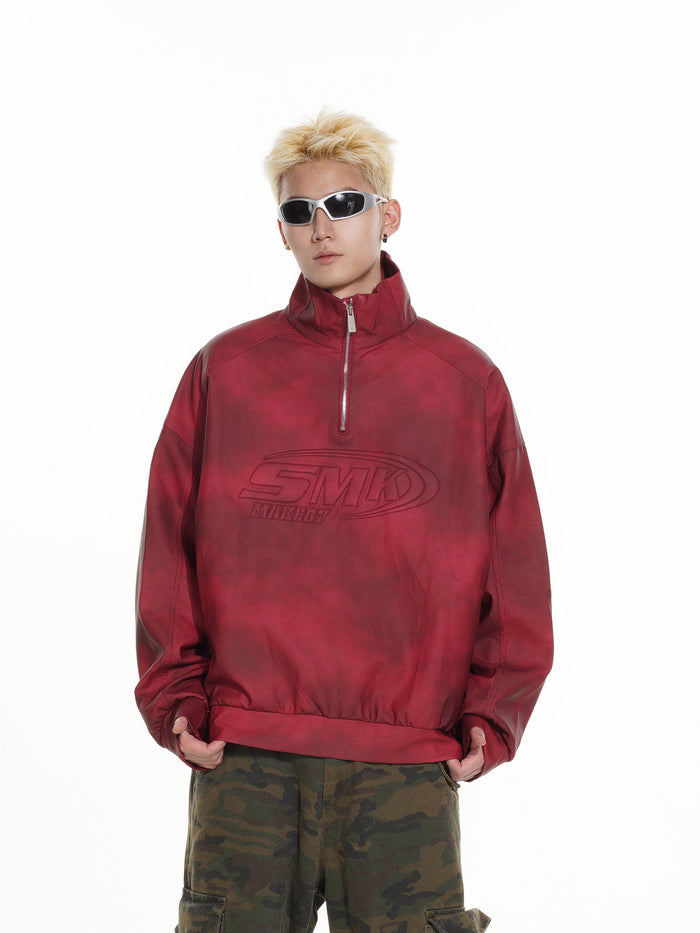 Model wearing a red acid-wash half-zip pullover with raised SMK chest graphic