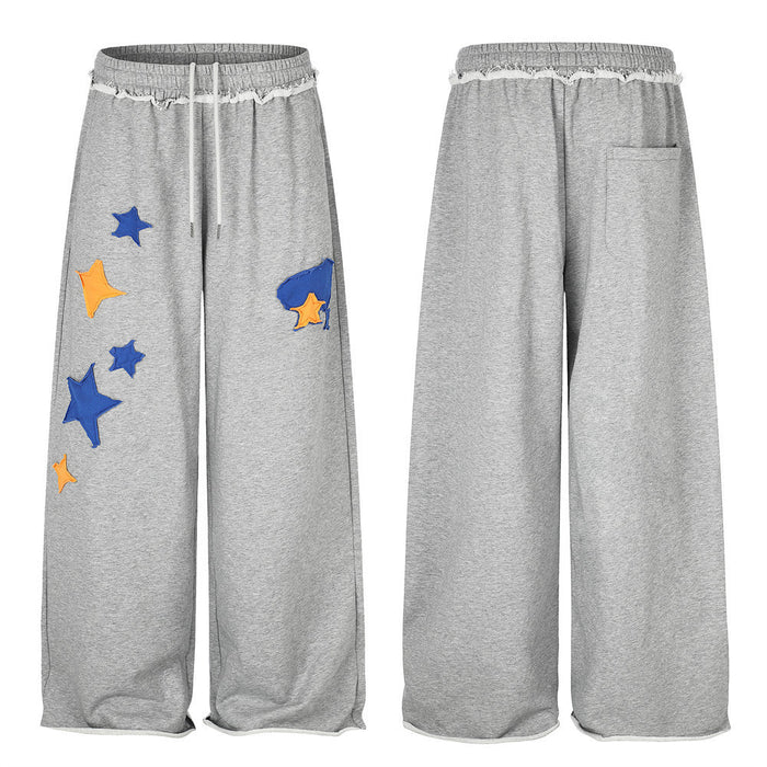 Gray wide-leg sweatpants shown front and back, with blue and orange star appliqués and a rear pocket