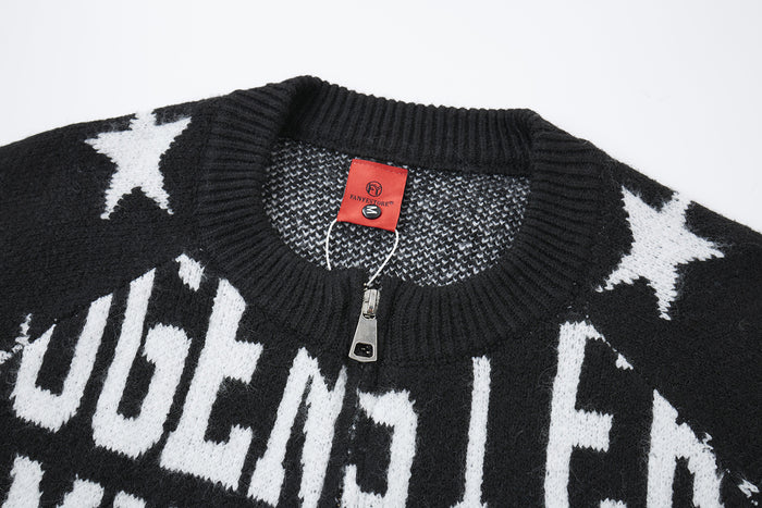 Close-up of the black cardigan's ribbed collar, zipper, red label, and white star knit pattern