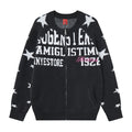 Front view of a black zip-up knit cardigan with white star sleeves, bold white lettering, and pink script