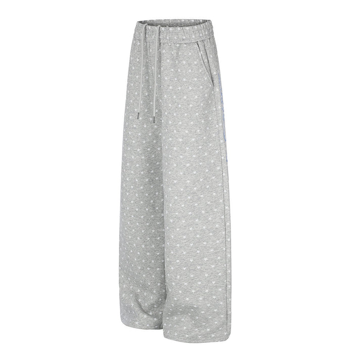 Gray star-print wide-leg sweatpants shown from a three-quarter front view with drawstring waist