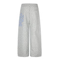 Gray wide-leg sweatpants with white stars and a blue star graphic on the outer leg