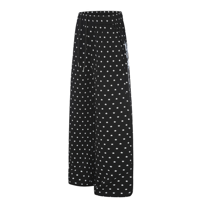 Black star-print wide-leg sweatpants shown from a three-quarter side view