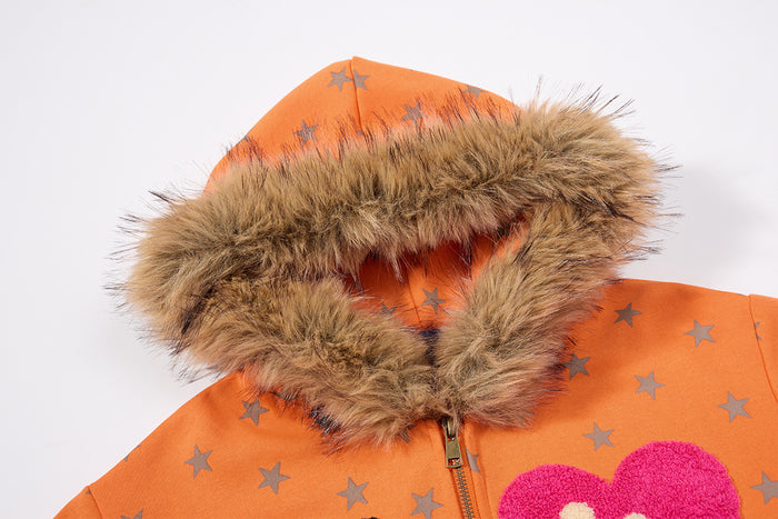 Close-up of orange hoodie hood with thick brown fur trim and gray star print