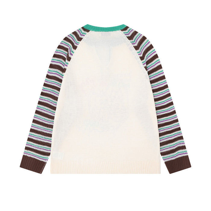 Back view of a cream knit pullover with brown, black, white, and teal striped raglan sleeves