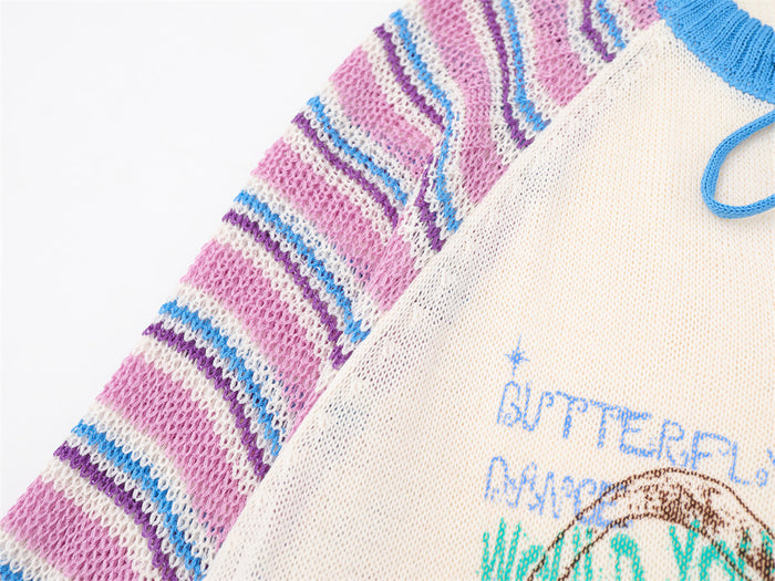 Close-up of the pink, blue, white, and purple striped raglan sleeve beside the cream knit body