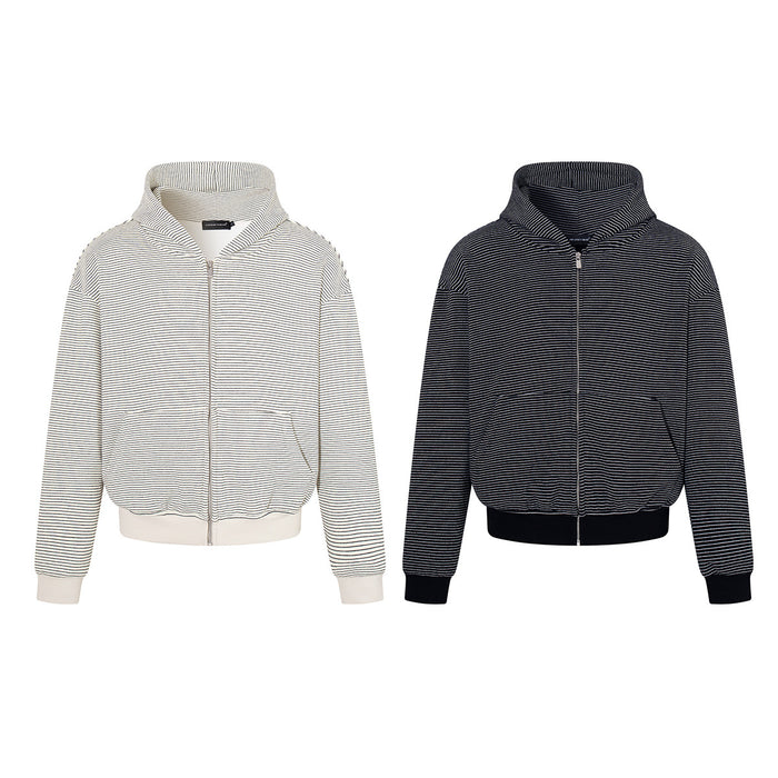 Two striped zip-up hoodies in cream and black, shown from the front with ribbed cuffs and hems