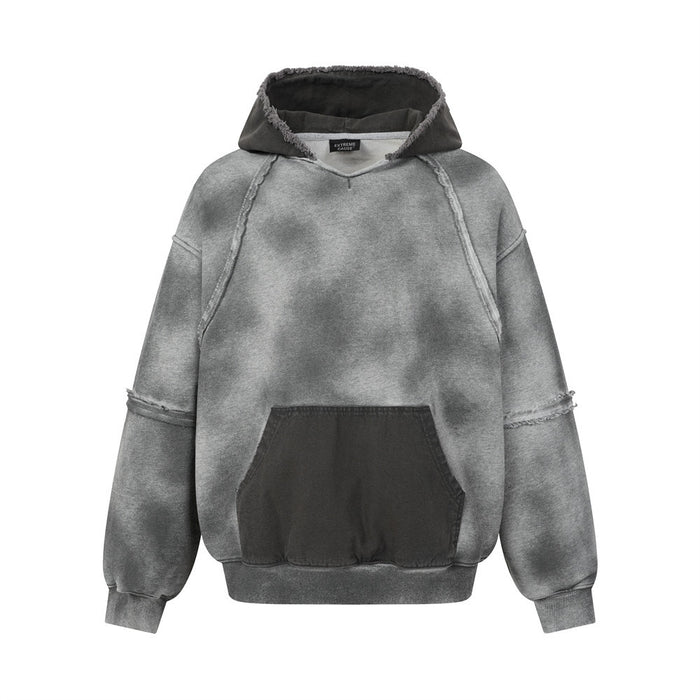Gray acid-washed pullover hoodie front with a dark kangaroo pocket and raw-edge seam details