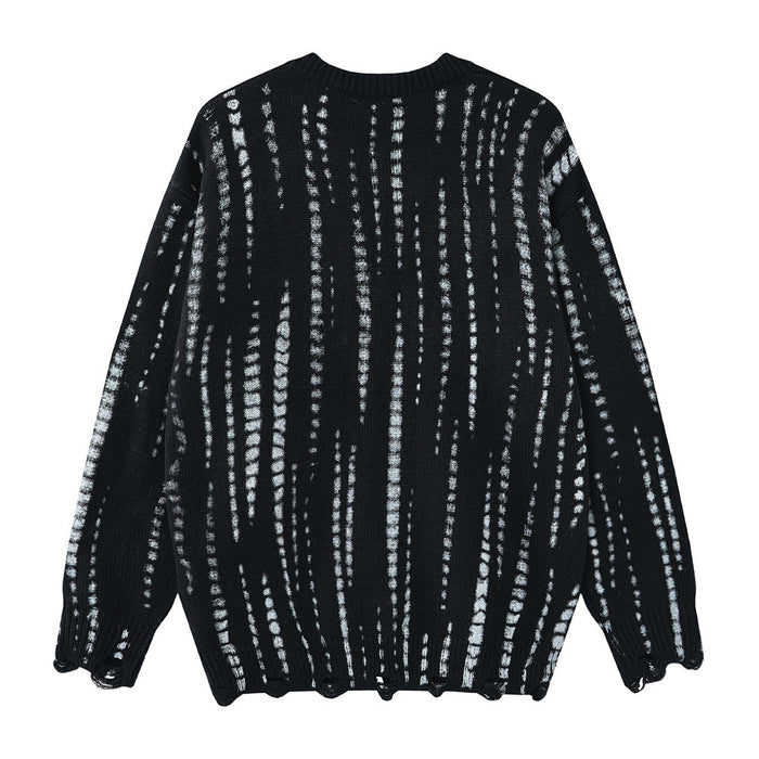 Back view of a black oversized knit sweater with irregular vertical distressed white stripes