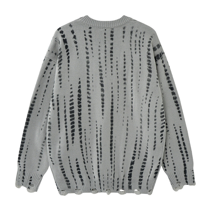 Back view of a gray oversized knit sweater with irregular black vertical distressed stripes