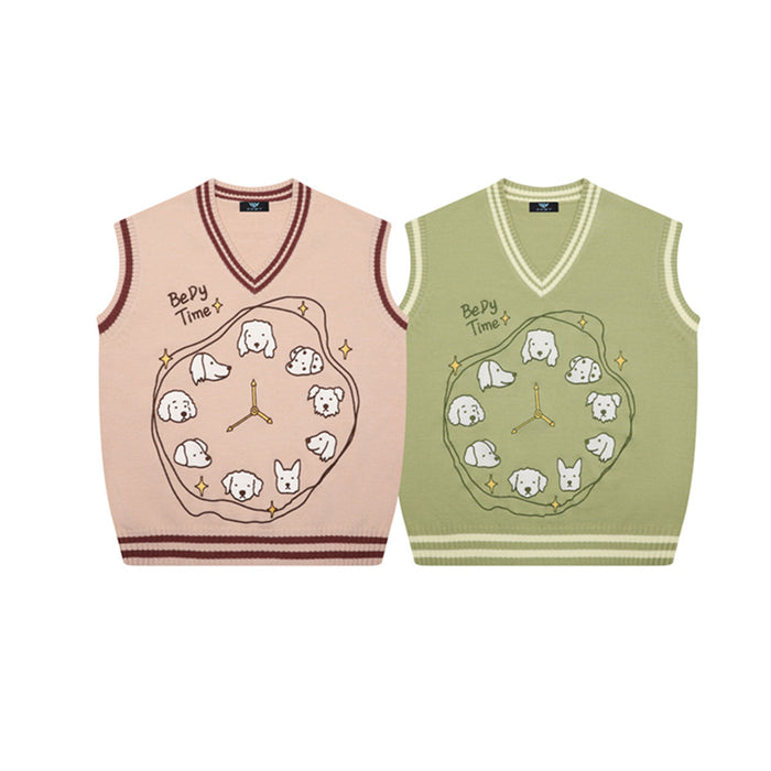Front view of pink and sage green V-neck sweater vests with dog clock graphics and striped trim