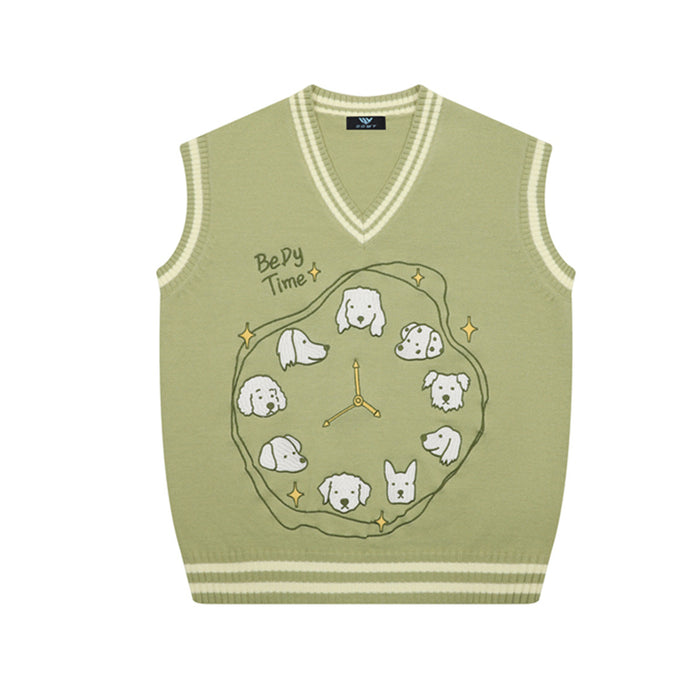 Front view of a sage green V-neck sweater vest featuring a clock surrounded by illustrated dogs