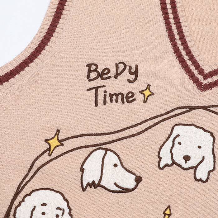 Close-up of the pink knit vest neckline and dog graphic with BeDy Time text and star details