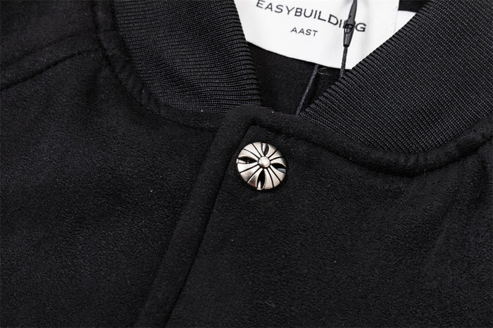 Close-up of the black bomber jacket collar and decorative snap button with ribbed trim and visible label