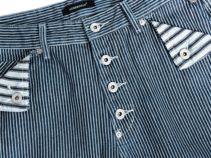 Detailed front view of the blue-and-white striped button fly with metal buttons and front pocket flaps